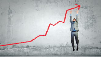 Image of young businessman jumping above graph-cropped